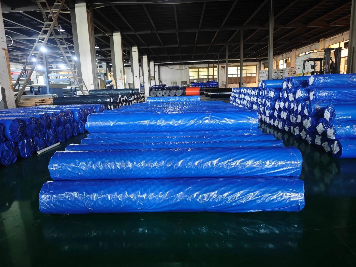 Wrapped finished woven fabric rolls stored for handling reference
